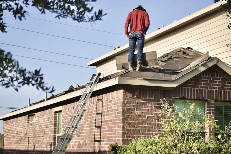 Professional roofer working on a residential roof in Brooklyn Center